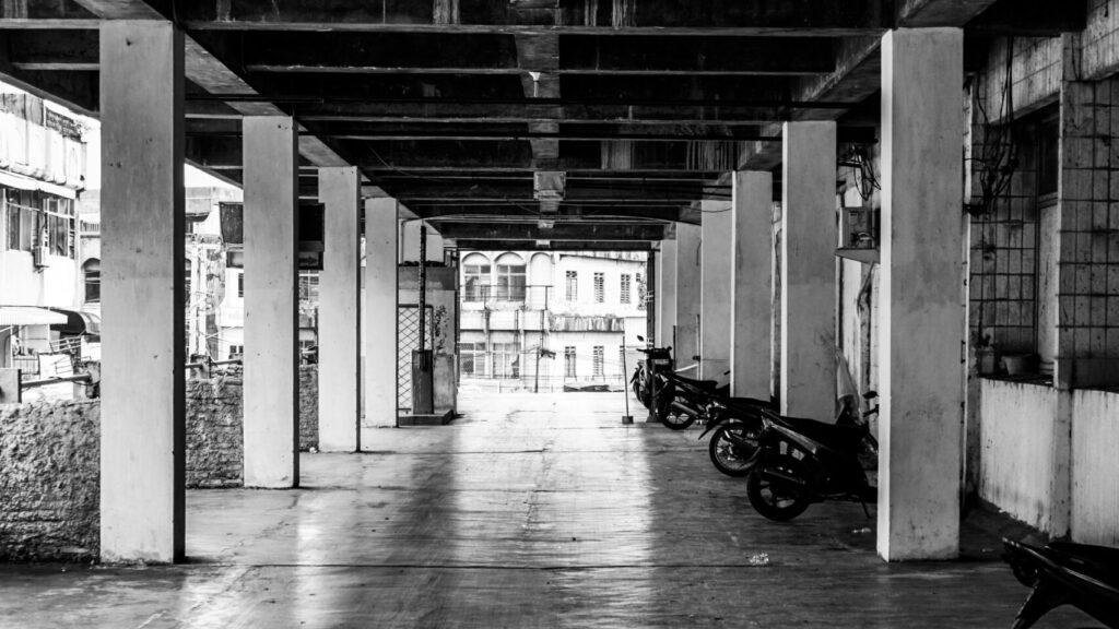 A black and white photo of parking garage